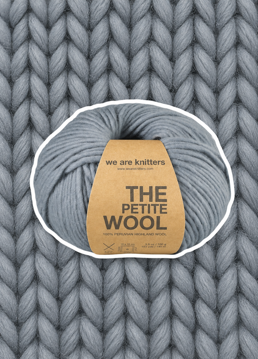 Petite Wool Grey yarn ball on a matching knit swatch