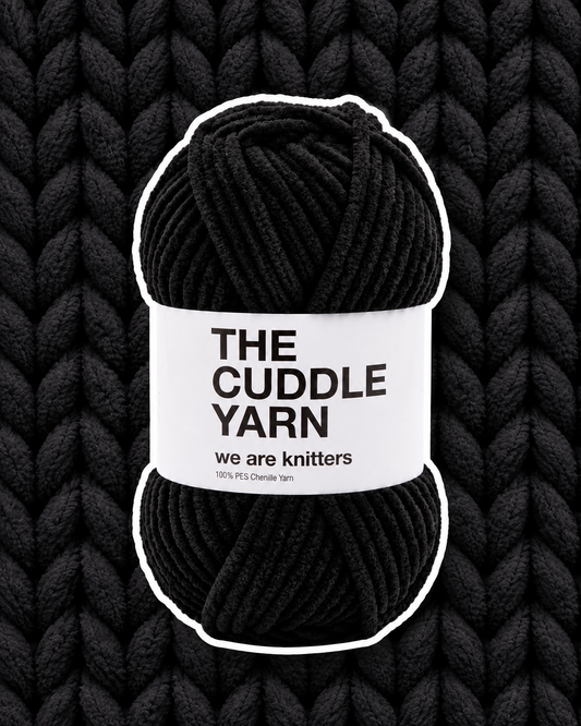 The Cuddle Yarn Black chenille skein on a matching knit swatch