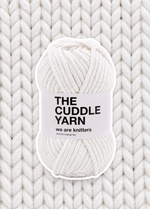 The Cuddle Yarn White chenille skein on a matching knit swatch